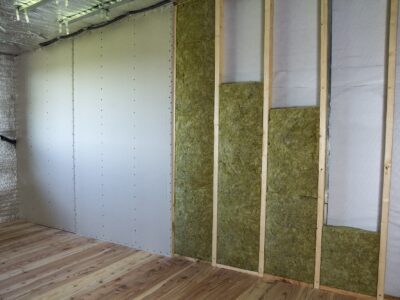 Wooden frame for future walls with drywall plates insulated with rock wool and fiberglass insulation